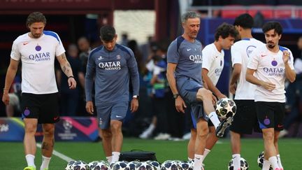 Luis Enrique entourant ses joueurs du PSG lors de la préparation à Budapest